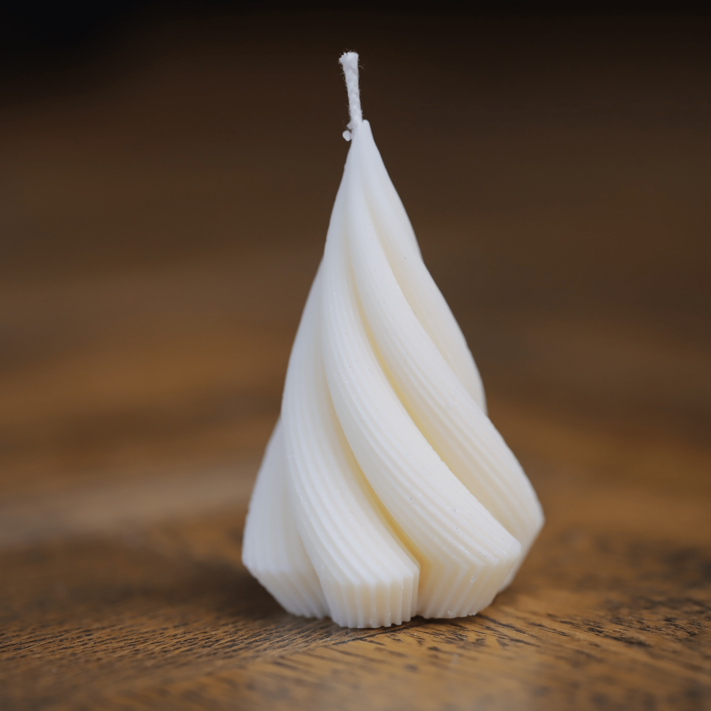 Bougie artisanale en cire naturelle avec une forme torsadée raffinée, apportant une touche d’élégance et de modernité à tout intérieur.